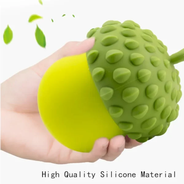10002 Dog playing with berry-shaped silicone treat dispensing toy in living room
