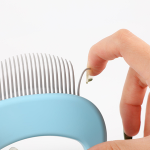 Close-up of pet grooming comb stainless steel needles for effective shedding and detangling