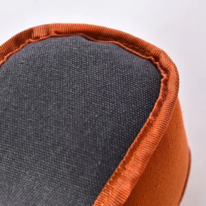 Close-up of chew cube dog toy with reinforced stitching and squeaky design for durability.