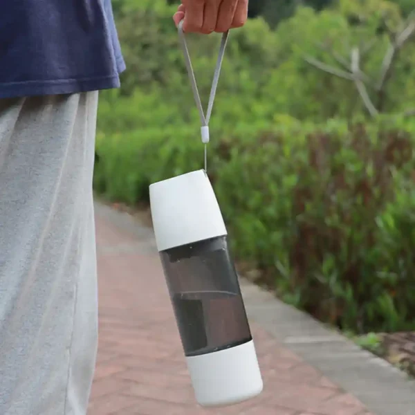 10004 Dog drinking from portable outdoor pet water bottle during walk
